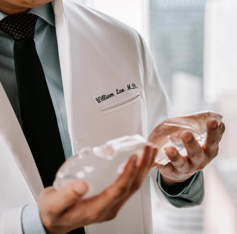 Dr. Lao holding silicon breast implants