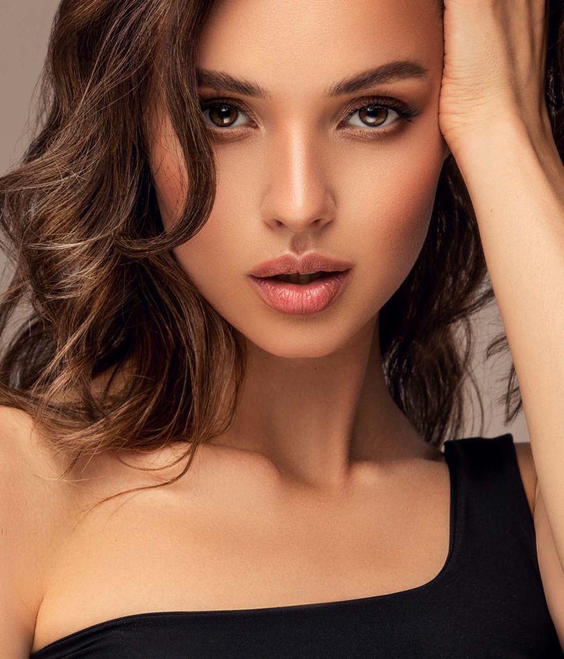 Close up portrait of a brunette woman with perfect skin and smile