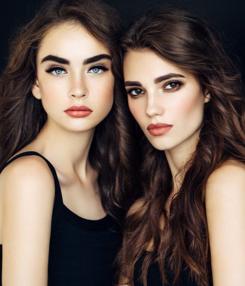 Two brunette women posing close together