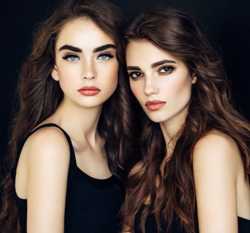 Two brunette women posing close together