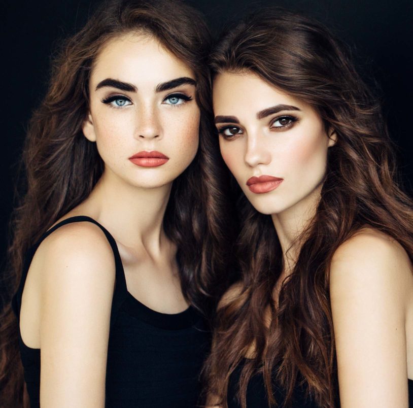 Two brunette women posing close together
