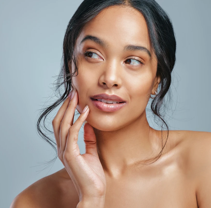 Woman touching her cheek and looking to her right