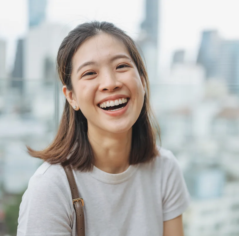 Woman head tilted back, smiling at the camera