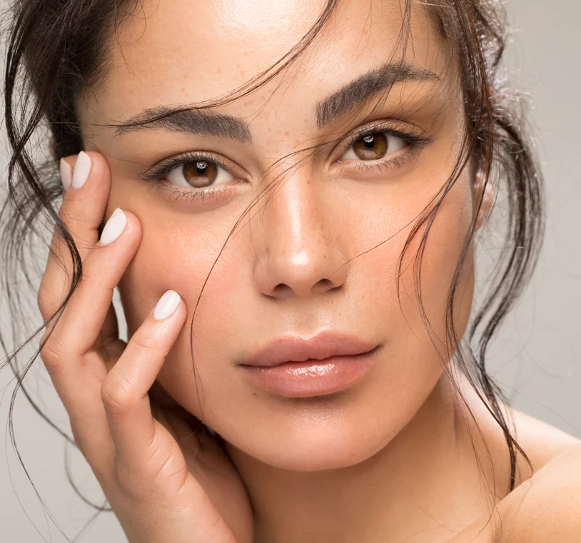 Close up portrait of a brunette woman with perfect skin and smile